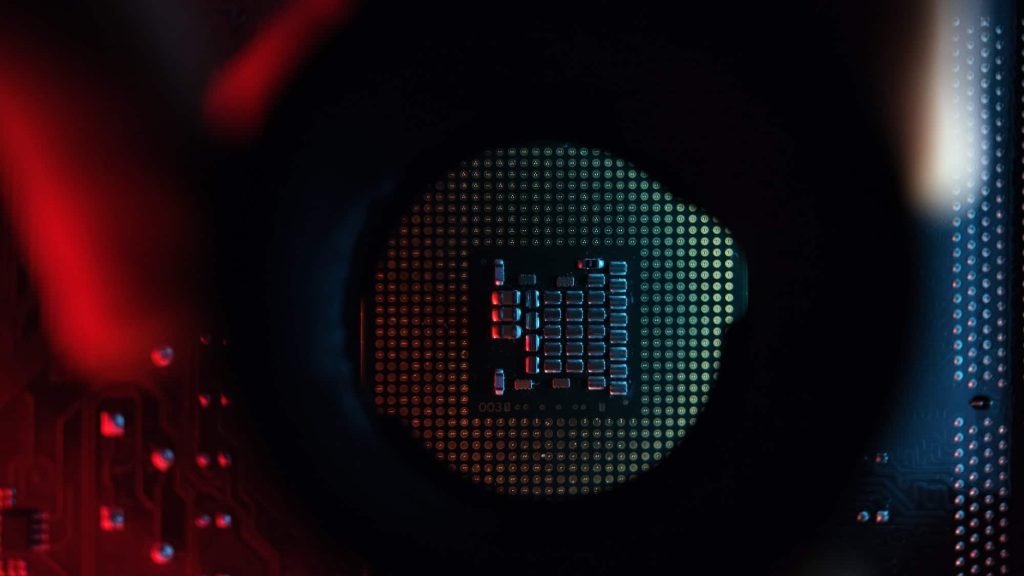 engineer-or-technician-examining-a-computer-processor-in-red-and-cyan-abstract-colors-close-up-.jpg
